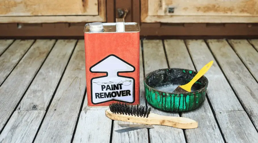 paint remover can with steel brush and paint brush on porch