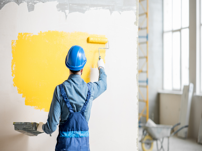 Man Paint a wall_Understanding the Lifespan of Paint on Your Walls